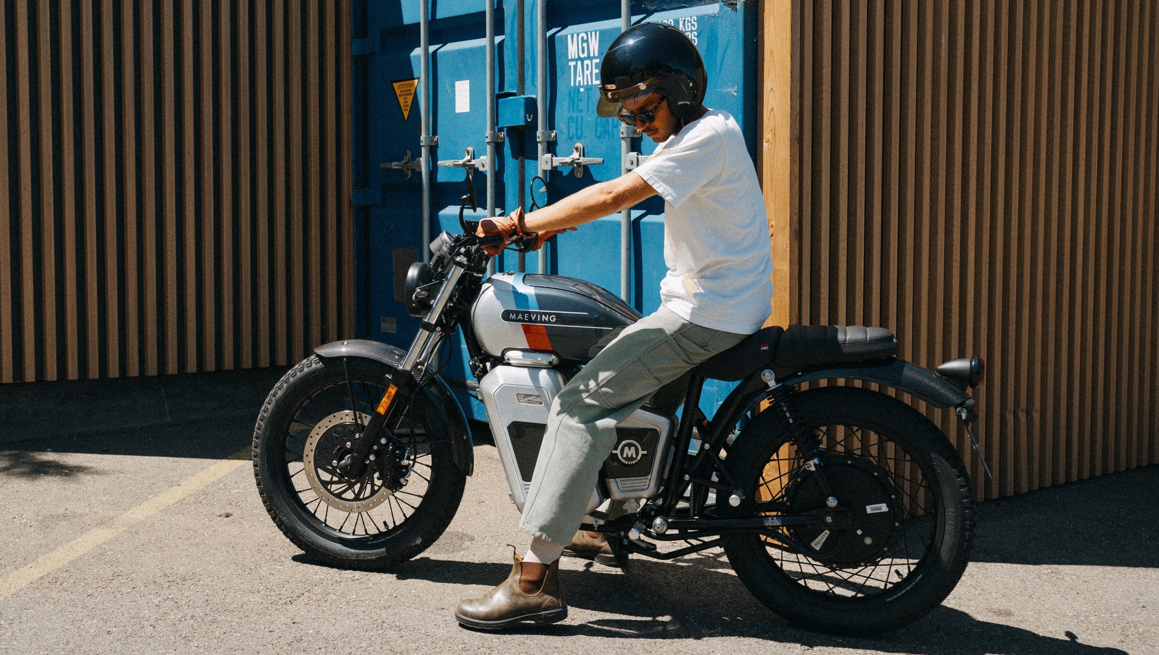 Maeving RM2 electric motorcycle parked with rider in sunshine